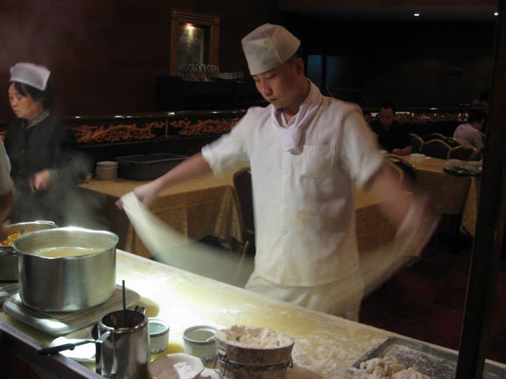 The process of preparing hand pulled noodles is so quick that it happens in a blur!