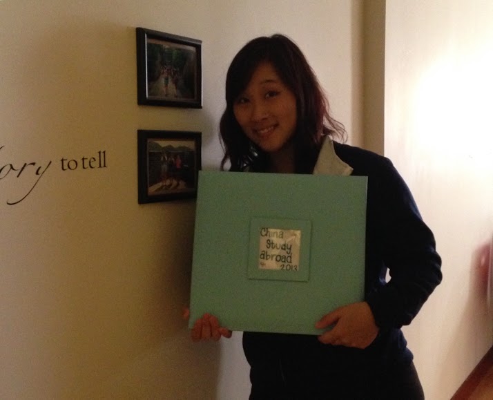 Kimberly Rogers holding the scrapbook she made after her study abroad trip to China. 